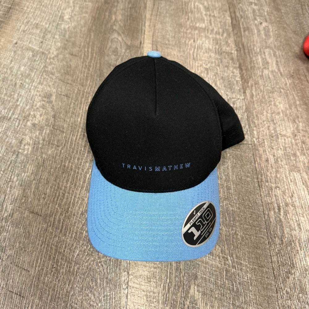 Travis Mathew Black Cap with Light Blue Brim - Picture 1 of 4